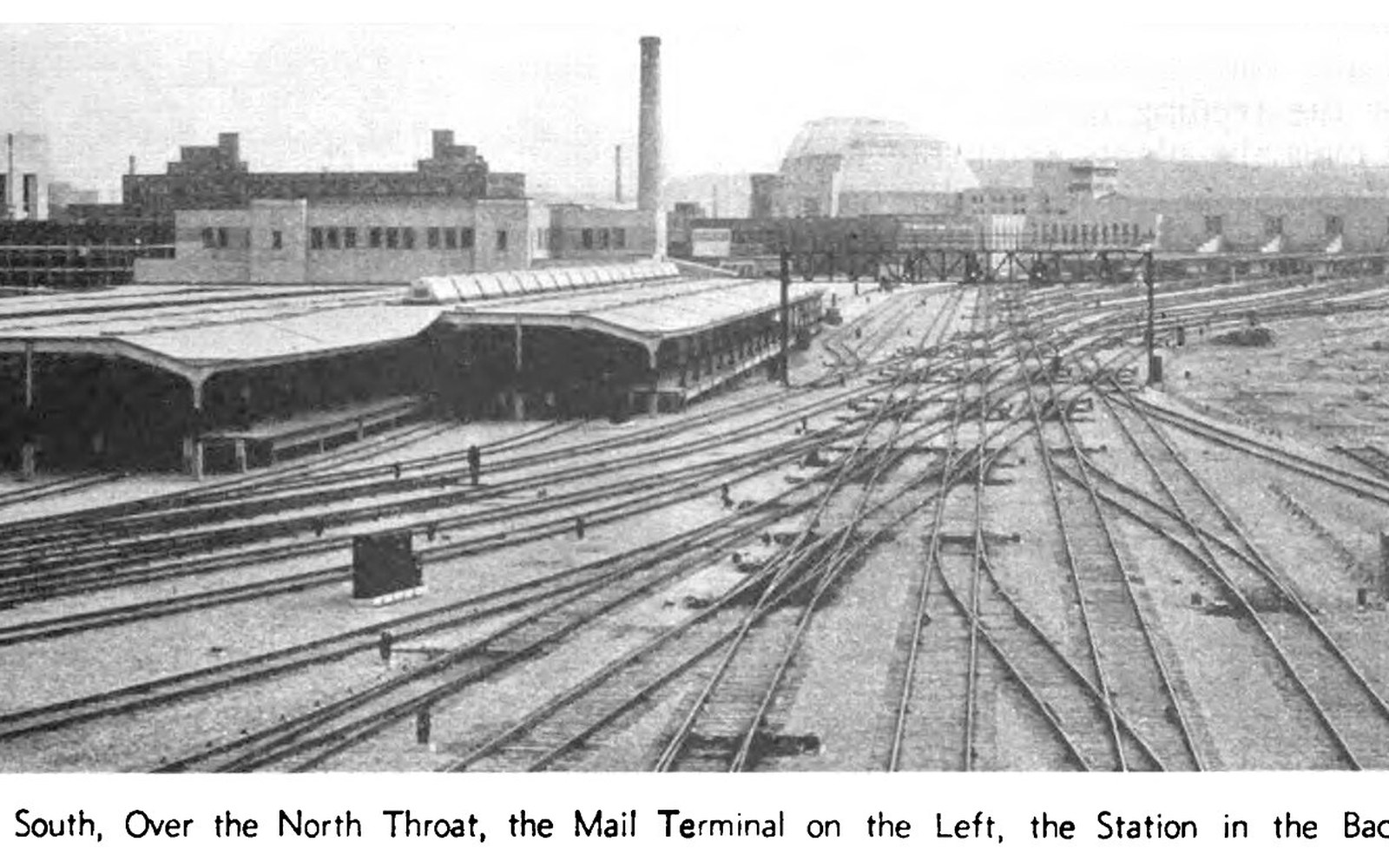 Converging rail tracks lead toward the mail terminal and domed station building beyond