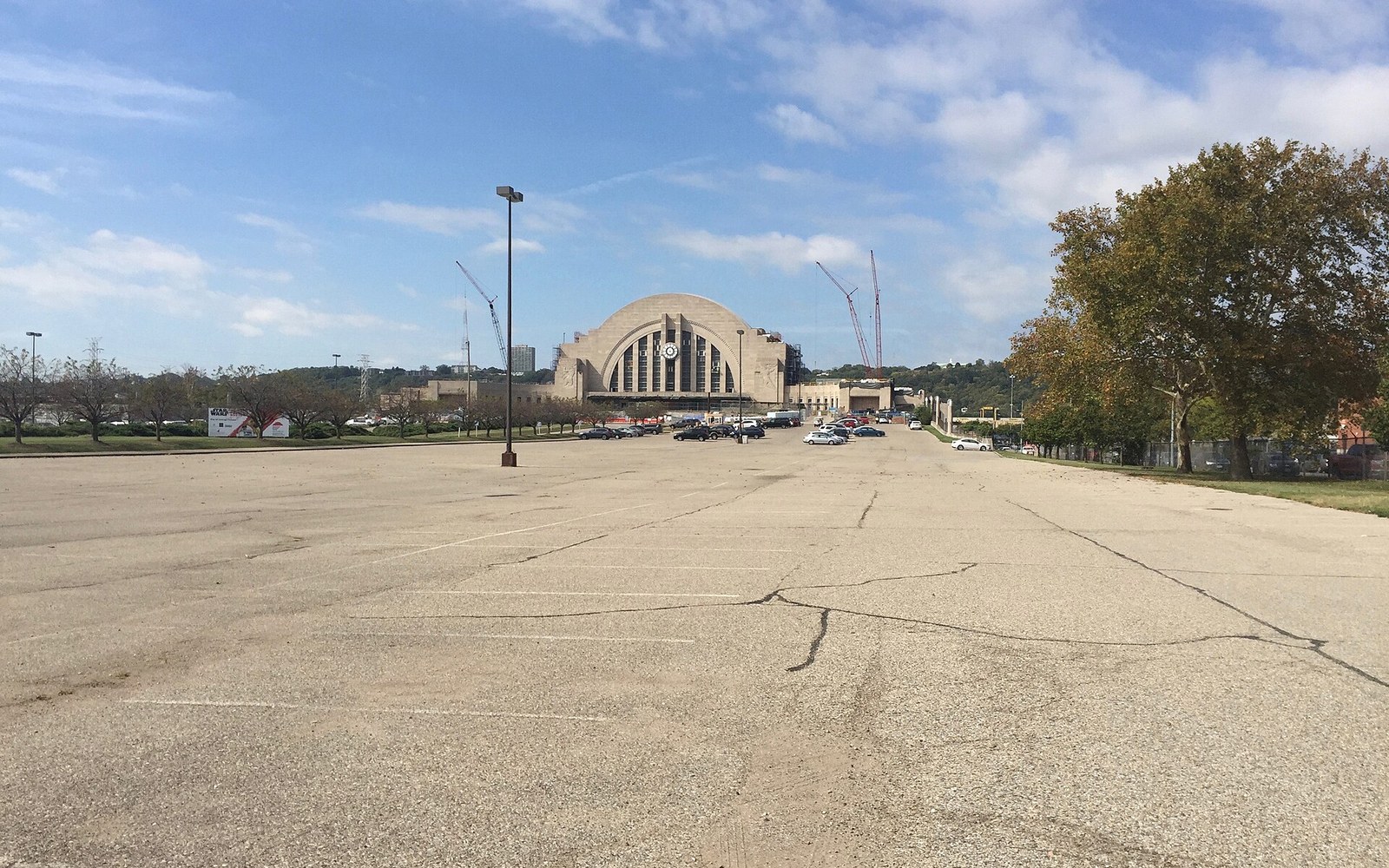 Union Terminal's arched facade viewed across a mostly empty parking lot